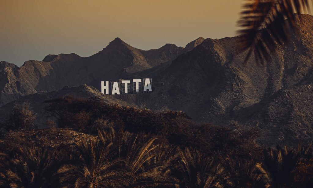 pexels-photo-10004805-10004805 Stunning view of Hatta mountains with signage at sunset, United Arab Emirates.