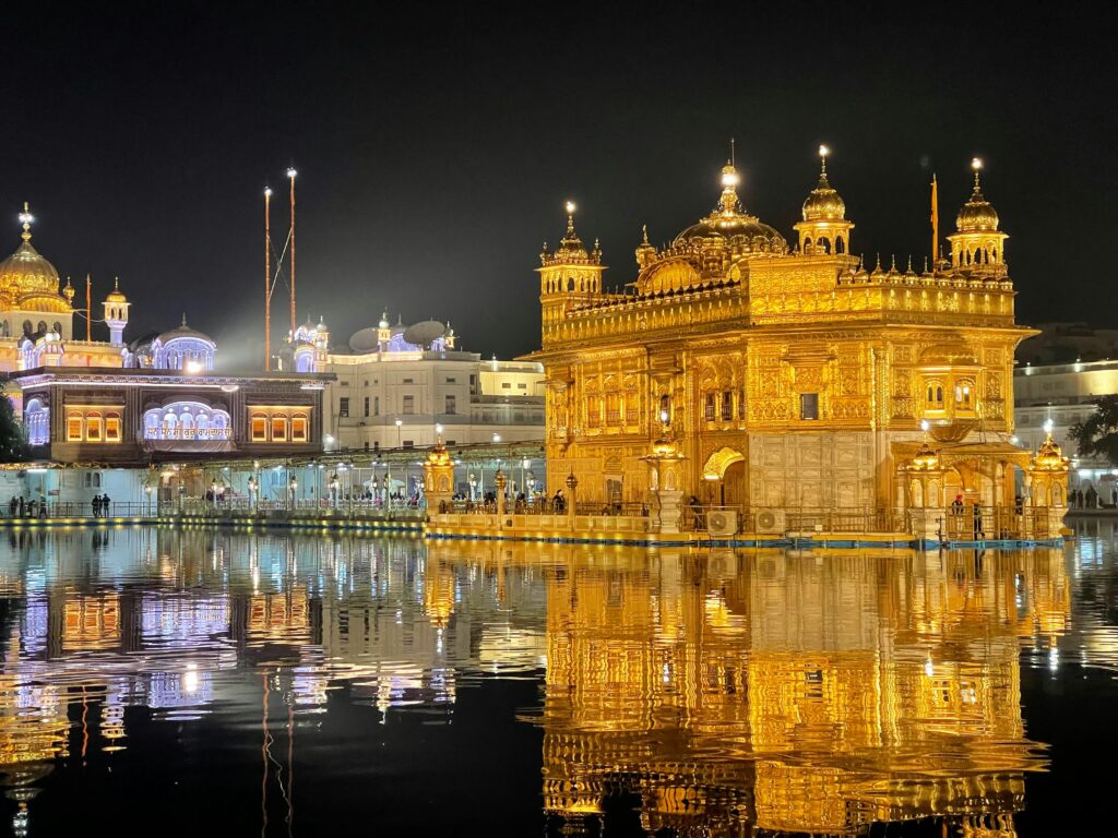 pexels-photo-12193697-12193697 Illuminated night view of the Golden Temple in Amritsar, India, with a stunning water reflection.