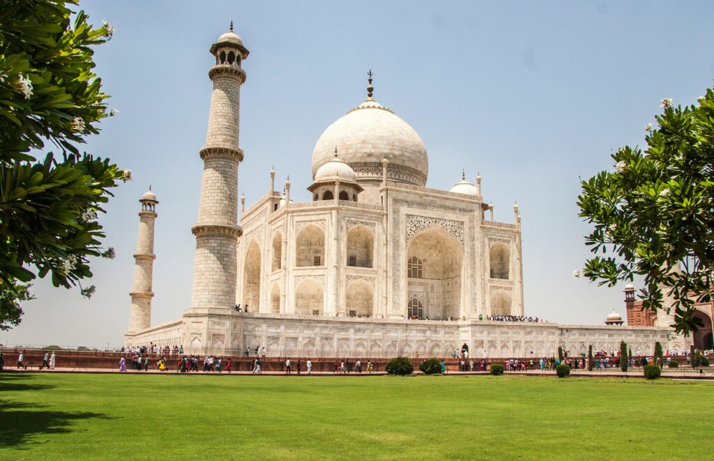 pexels-photo-1583339-1583339 Iconic Taj Mahal showcasing its white marble beauty and lush gardens on a sunny day.