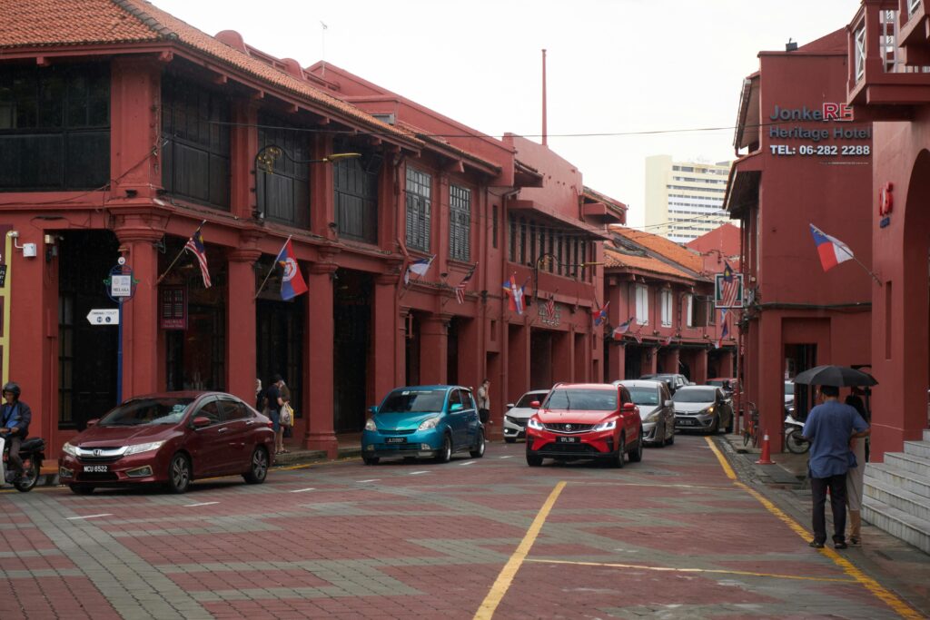 Captivating view of heritage buildings and traffic in Malacca, Malaysia.