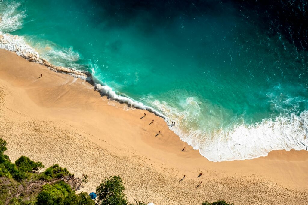 pexels-photo-1802183-1802183 Stunning aerial view of Bali's beach with turquoise waves crashing on golden sand.