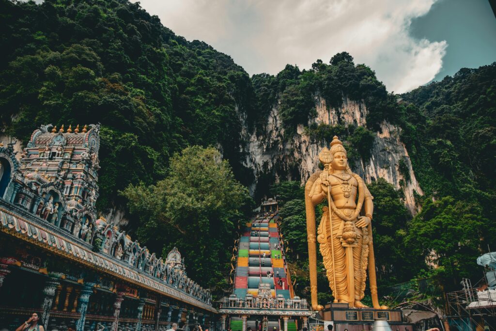 Breathtaking view of the iconic Lord Murugan statue and colorful steps at Batu Caves, Malaysia.