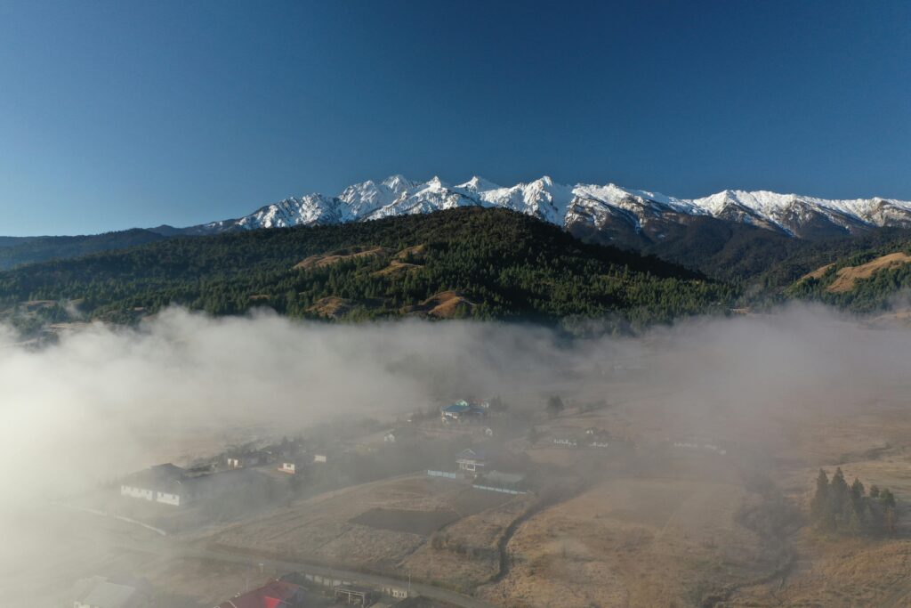 pexels-photo-19946580-19946580 A breathtaking view of a misty valley with snowy mountains in Kargong, perfect for nature and travel enthusiasts.