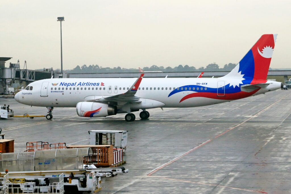 pexels-photo-20625973-20625973 Nepal Airlines Airbus A320 stationed on airport runway, ready for departure.