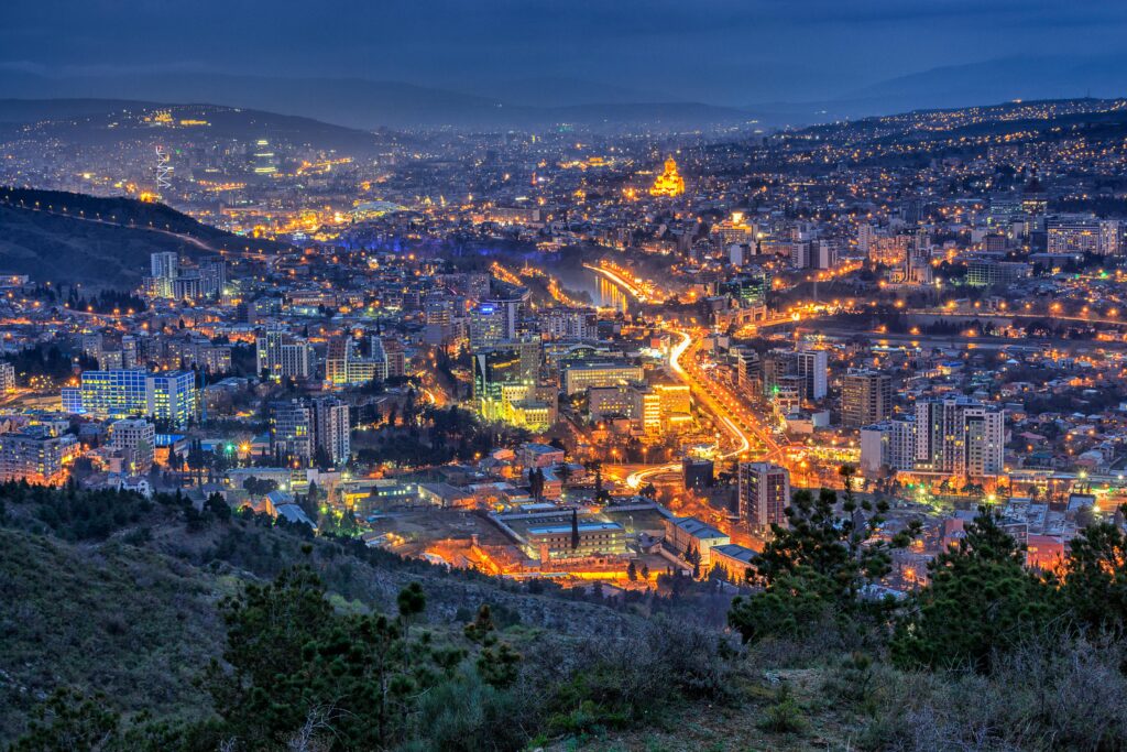 pexels-photo-2101159-2101159 Aerial view of Tbilisi's illuminated cityscape at night, showcasing vibrant urban architecture.