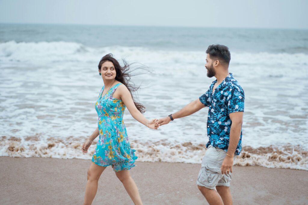 pexels-photo-21837078-21837078 Smiling couple holding hands and walking along the beach in Puri, India. Perfect for vacation imagery.