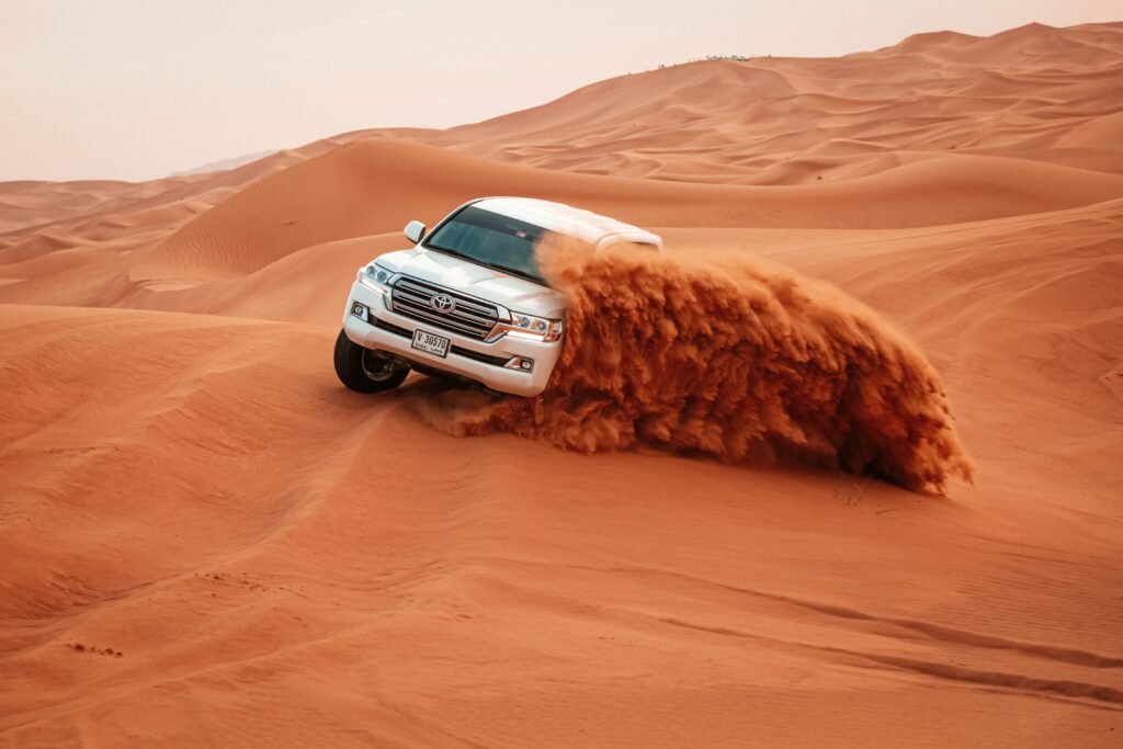 pexels-photo-4781951-4781951 A Toyota Land Cruiser drives through the vast sandy dunes on an exciting off-road adventure.