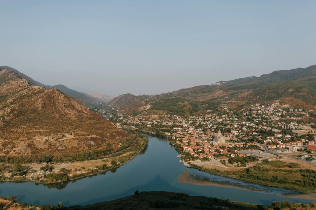 Aerial view of Mtskheta with Aragvi river, showcasing the picturesque landscape of Georgia.