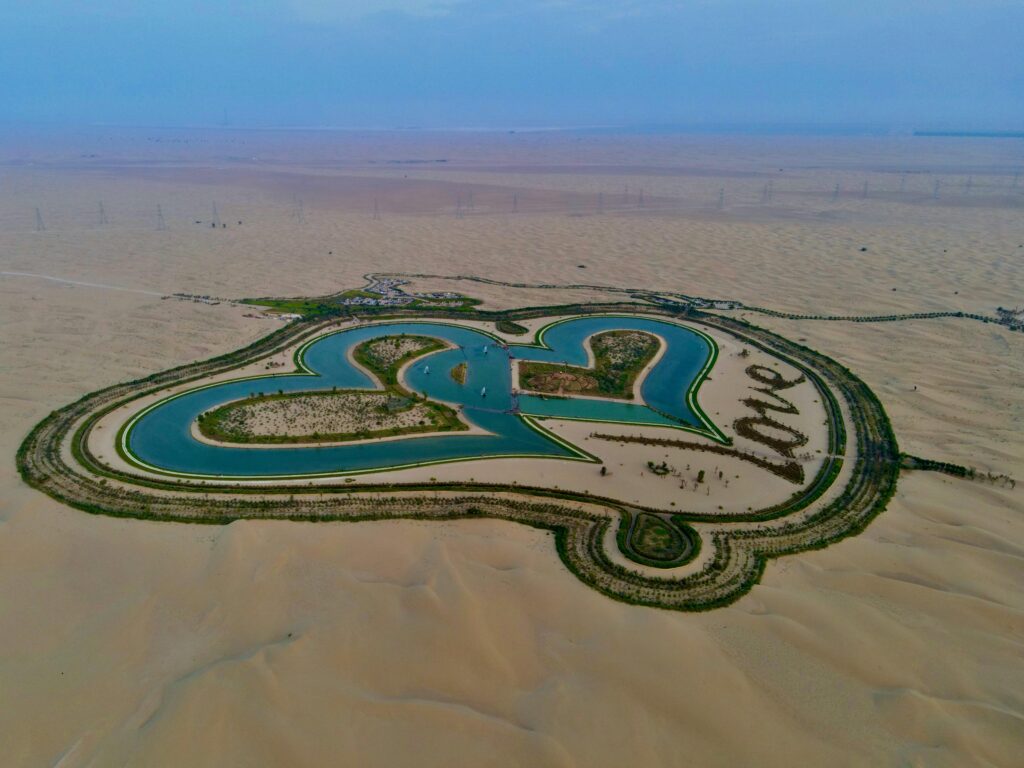pexels-photo-5855866-5855866 Drone shot of a heart-shaped oasis surrounded by desert landscape, symbolizing love.