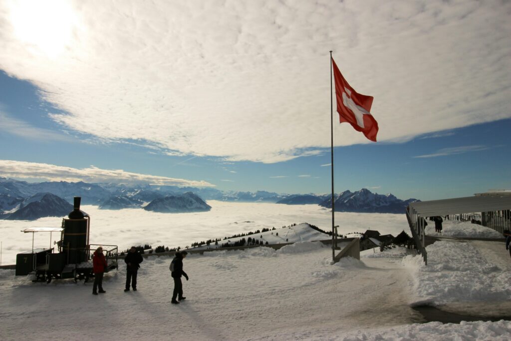pexels-photo-773473-773473 Majestic snowy view from Rigi Kulm, Switzerland, with Swiss flag and mountains.
