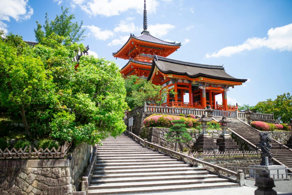 pexels-photo-8369857-8369857 Scenic view of a traditional Japanese pagoda surrounded by lush greenery and clear blue sky.