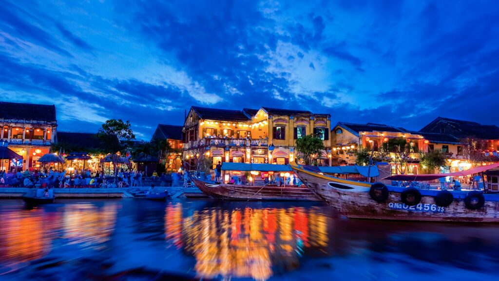 pexels-photo-92090-92090 Enchanting view of Hội An's riverside with colorful lights reflecting on water at night.