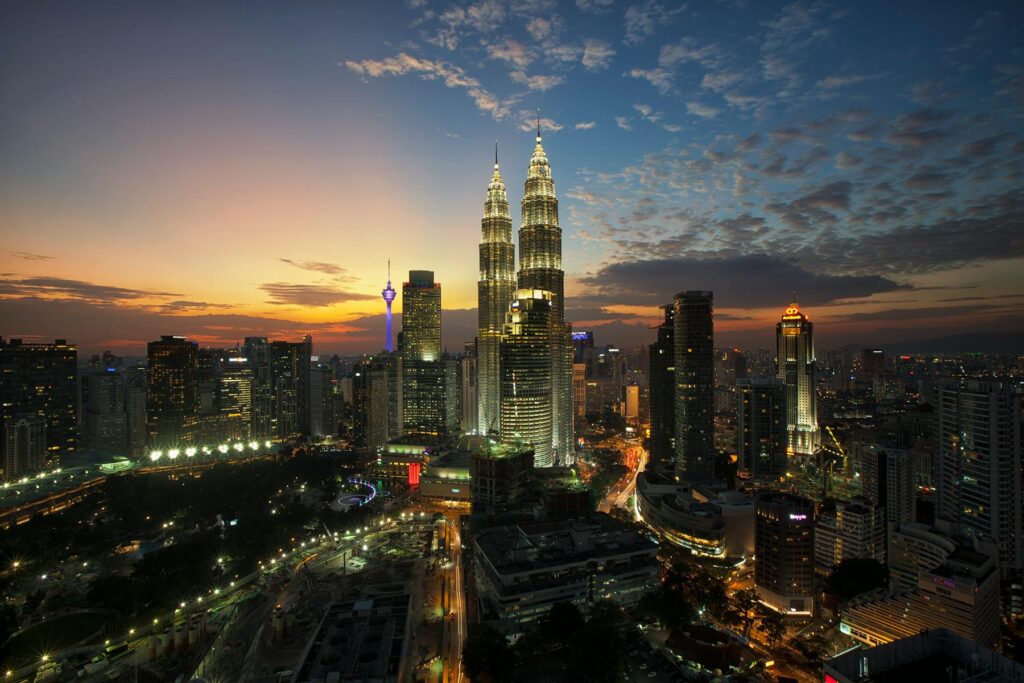 pexels-photo-92225-92225 Discover the iconic Kuala Lumpur skyline with the Petronas Towers at twilight, showcasing the vibrant city lights.