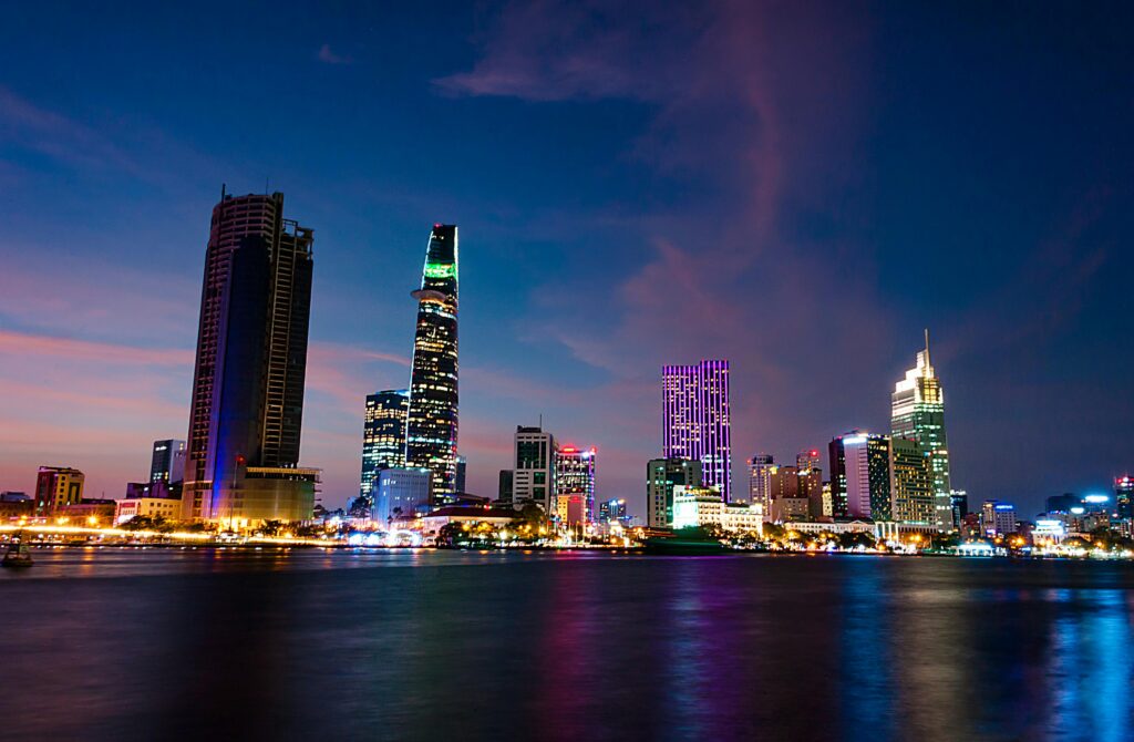 pexels-photo-941195-941195 A stunning evening view of Ho Chi Minh City's skyline reflecting vibrant lights over the Saigon River.