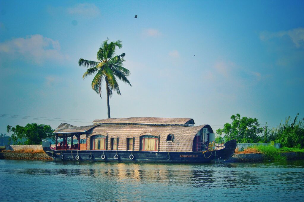 pexels-photo-962464-962464-1 Picturesque view of river with green palms on bank and shabby wooden boathouse under blue sky in tropical countryside